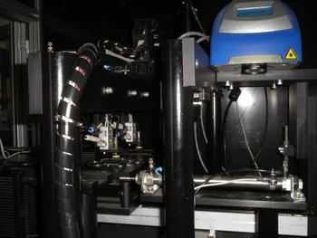 System adjusting to inspect different resistor sizes on a wafer using an automated setup with a motorized lens.