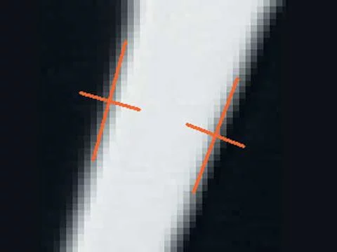Enlarged edge with two marked measurement points, captured using subpixel-accurate 1D measurement in MVTec HALCON.