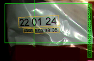 Machine vision inspection detecting printed date and code information on food packaging for quality assurance.