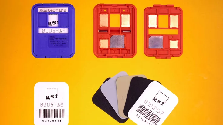 X-ray film dosimeter badges and opened cassettes with different metal filters inspected by a machine vision system.