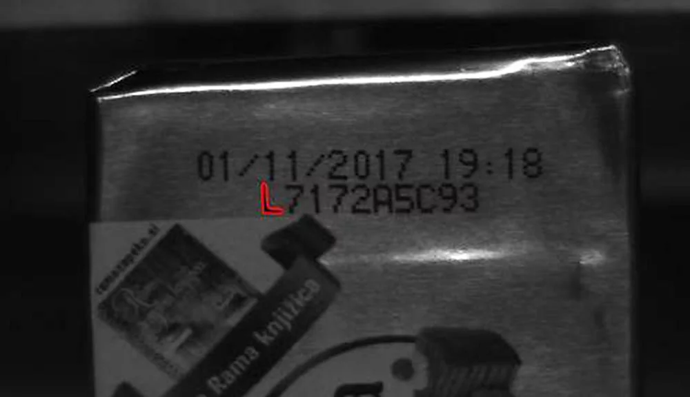 OCR process identifying a specific character model in printed text on packaging.