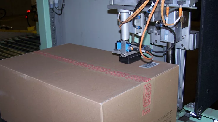 Package label with barcode and printed text used for automated barcode reading and OCR.