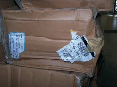 Damaged package label that is difficult to read for barcode and OCR systems.