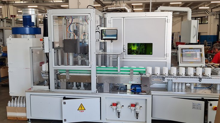 Aluminum bottles on a production line identified by OCR using machine vision for automated quality control.