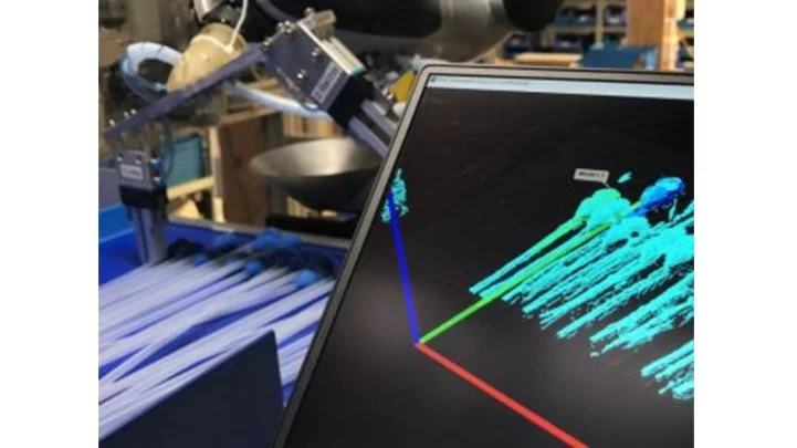 Bin picking application using machine vision to locate and grip medical catheters in random orientations for automated packaging.