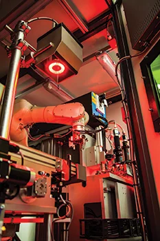 A robotic system with a vision camera inspecting automotive parts for quality assurance.