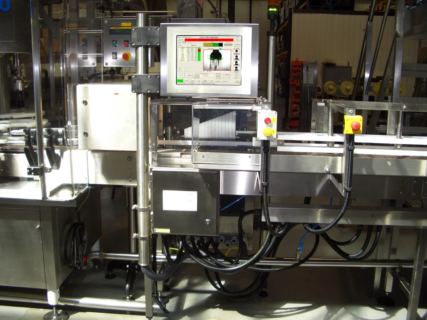 Bottle inspection system installed in a bottling plant for automated quality control.