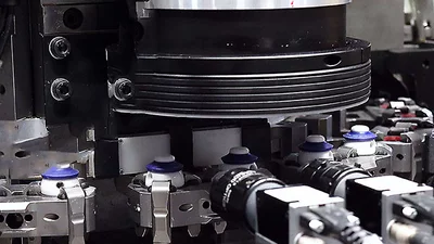 Bottle caps checked inline for cracks using automated machine vision.