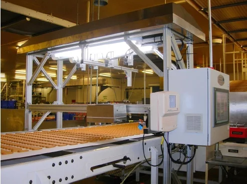 Automated biscuit inspection system installed on a production line for measuring size and quality at high throughput.