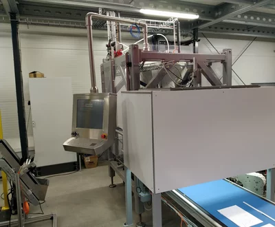 Exterior view of a compact pick-and-place system supported by machine vision for automated food handling.