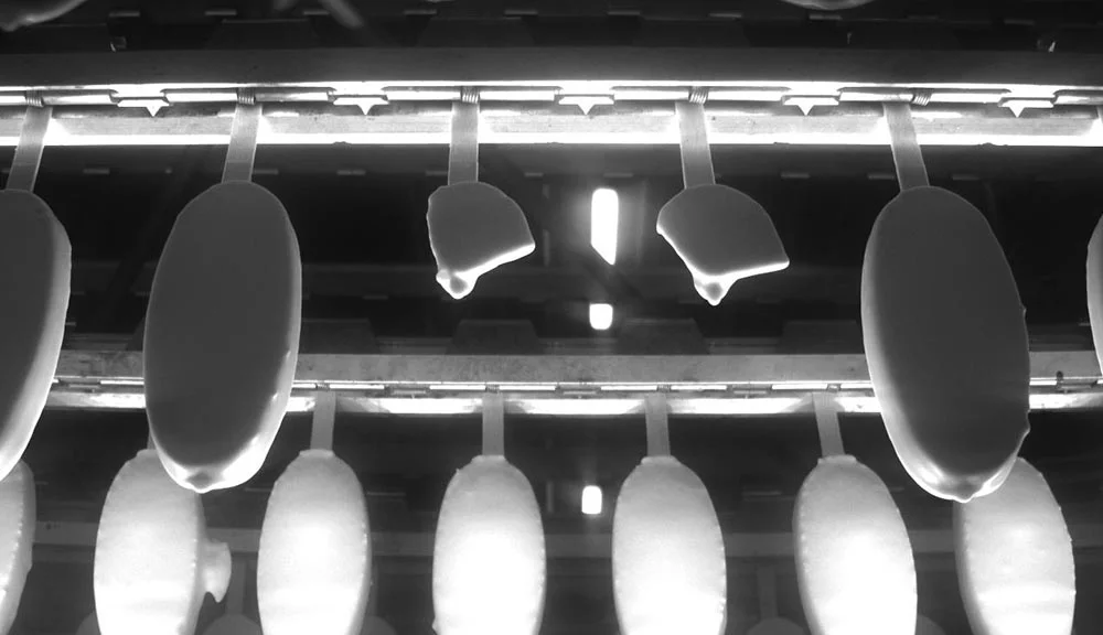 Broken and deformed ice creams as seen by a machine vision camera during quality inspection.