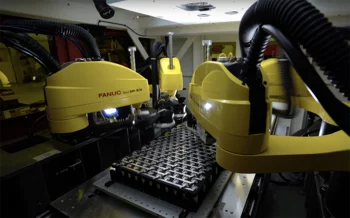 Industrial robots performing laser welding on battery cells guided by machine vision.