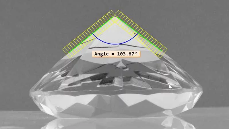 Crystal with marked angle measurement of 103.87° through subpixel-accurate 2D measurement in MVTec HALCON.