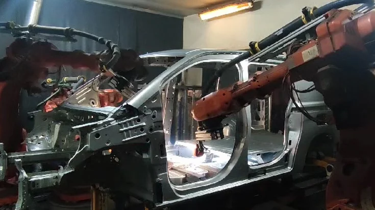 Robotic welding cell inspecting car body weld seams using machine vision.