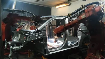 Robotic welding cell inspecting car body weld seams using machine vision.