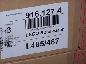 Package label with barcode and printed text used for automated barcode reading and OCR.