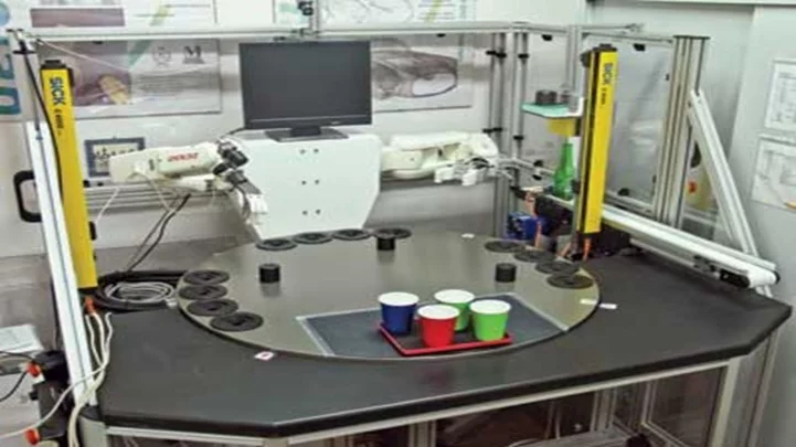 Vision-guided robotic bartender system with dual robot arms serving drinks using machine vision and robotics.