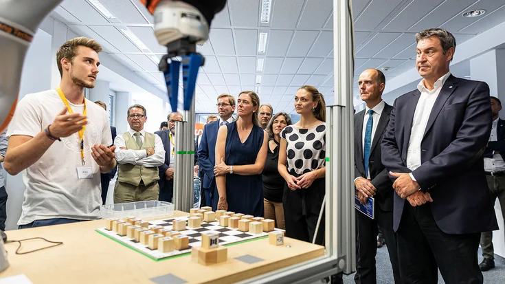 Students and researchers using a robot with machine vision in a university lab to demonstrate the impact of MVTec HALCON on education and research.