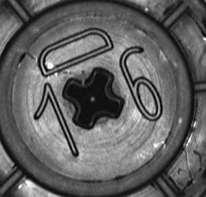 Close-up image of a molded part showing the cavity number inspected using OCR for defect detection.