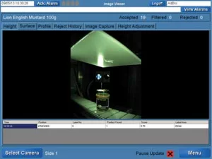 Vertically mounted camera inspecting the top of a food jar using diffused lighting for lid and seal verification.