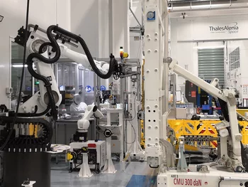 Industrial robot placing optical solar reflectors on a satellite panel guided by machine vision software.