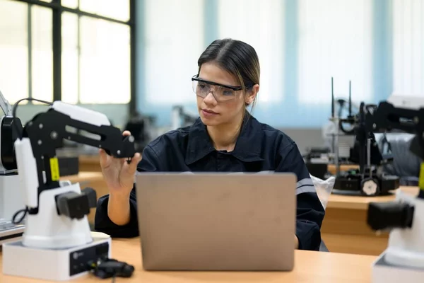 Technician engineer works at a laptop and a camera.