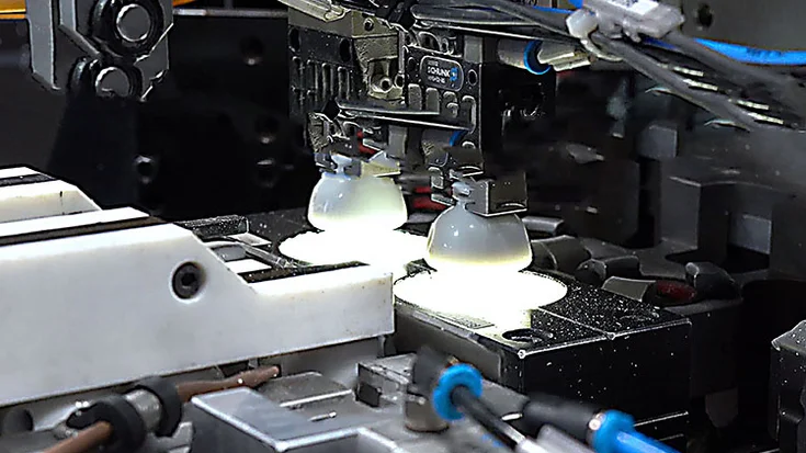 Bottle caps inspected by machine vision to verify print quality in beverage production.