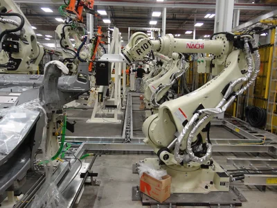 A close‑up view of an industrial camera mounted directly on the robot’s gripper for flexible inspection positioning.
