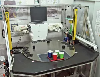 Vision-guided robotic bartender system with dual robot arms serving drinks using machine vision and robotics.