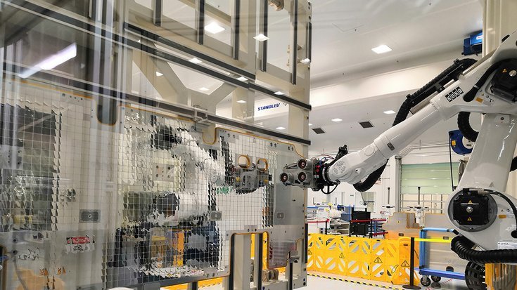 Robotic manufacturing cell assembling satellite panels with optical solar reflectors using machine vision.